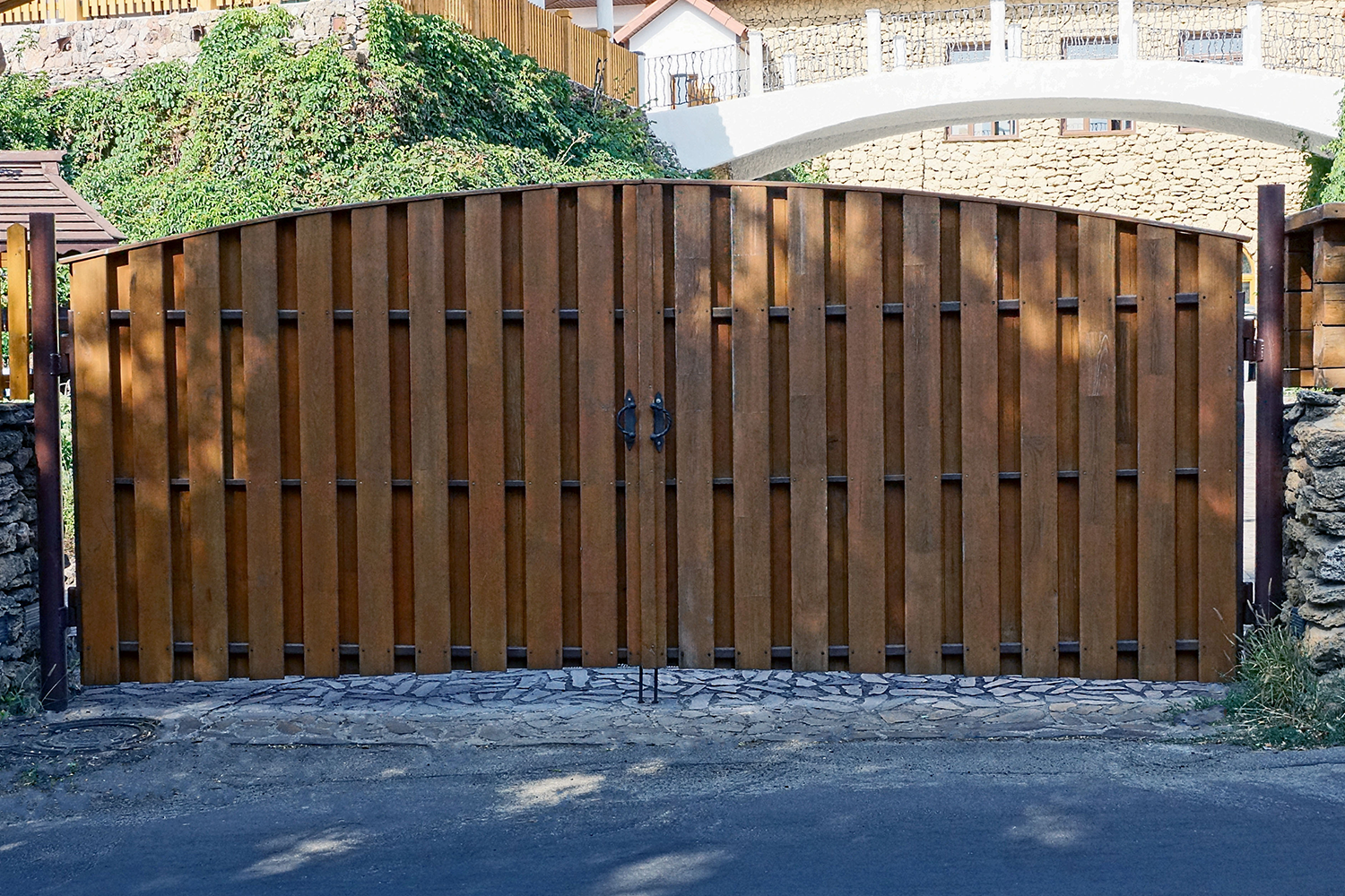 A wooden fence with a bridge in the background.