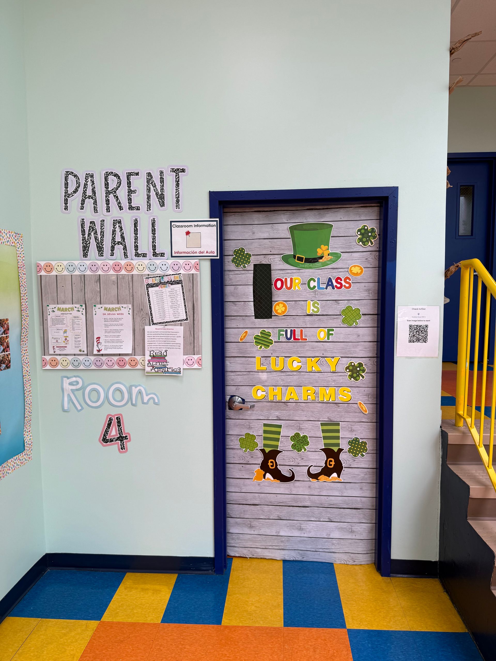 A classroom door and adjacent parent wall decorated for St. Patrick's Day with shamrocks and leprechaun-themed graphics.