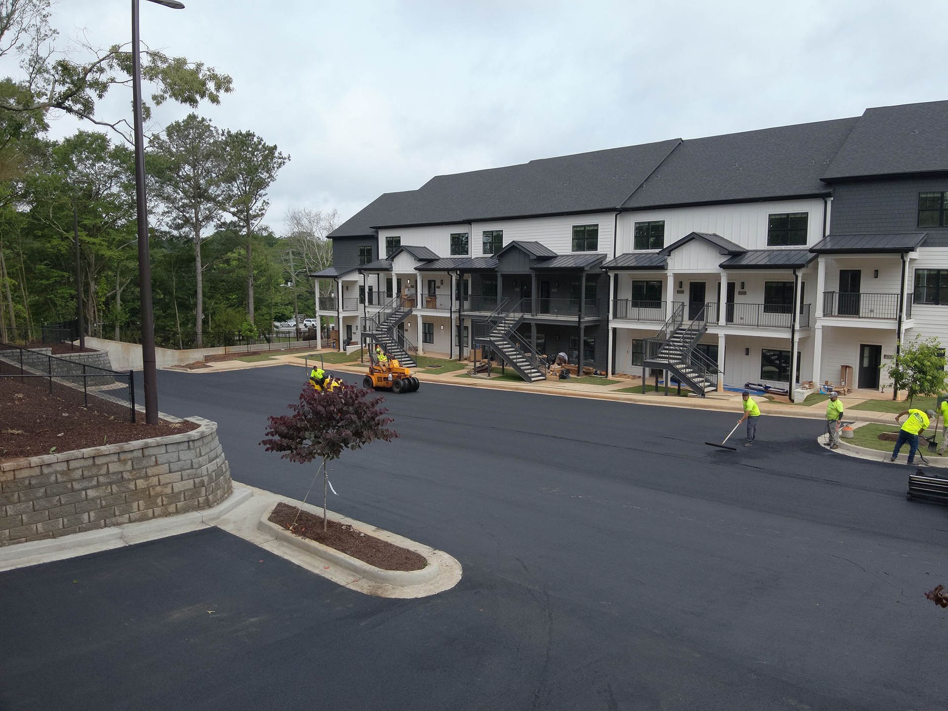 Asphalt paving in progress in front of new townhouses.