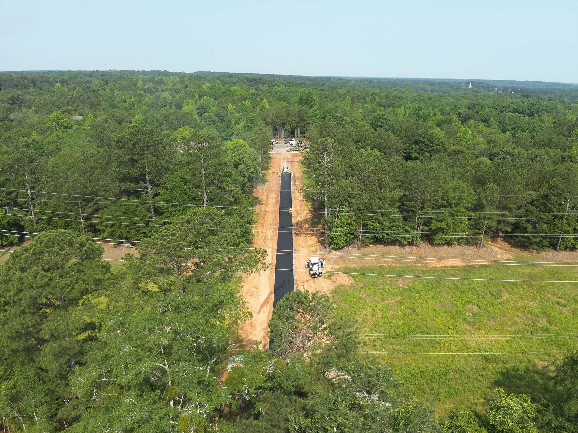 Aerial view of a cleared path through a forest for a road or utility line.