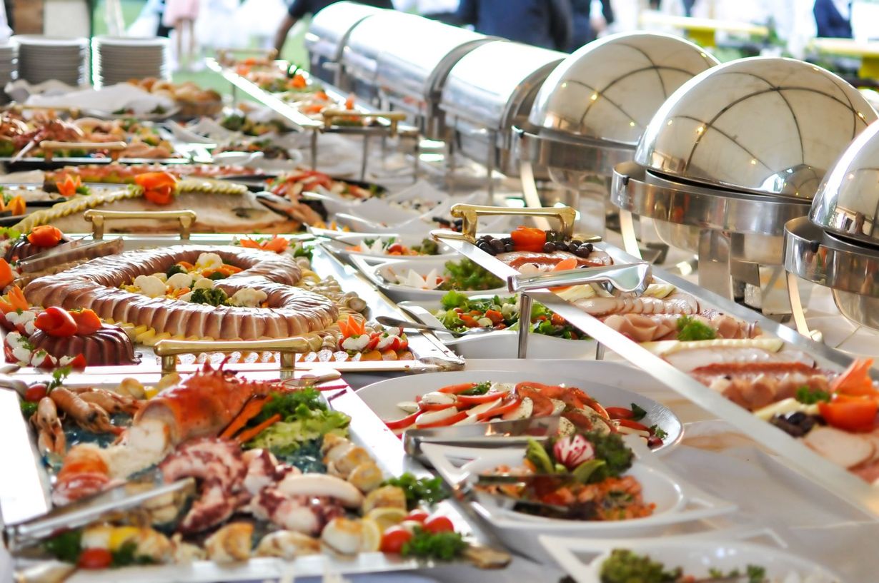 Buffet with various seafood and dishes, including lobster, crab, and salads.