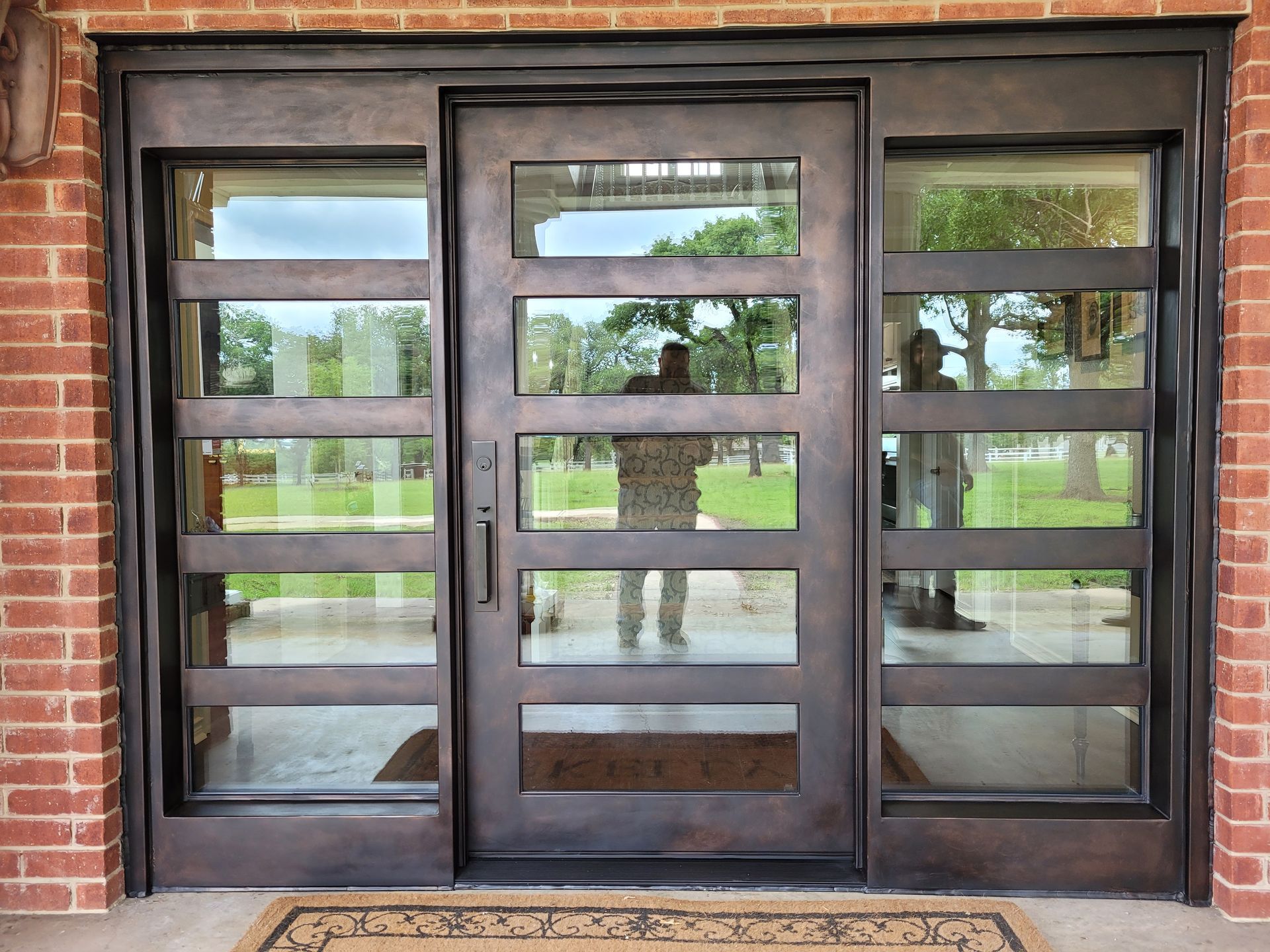 A brick building with a large glass door