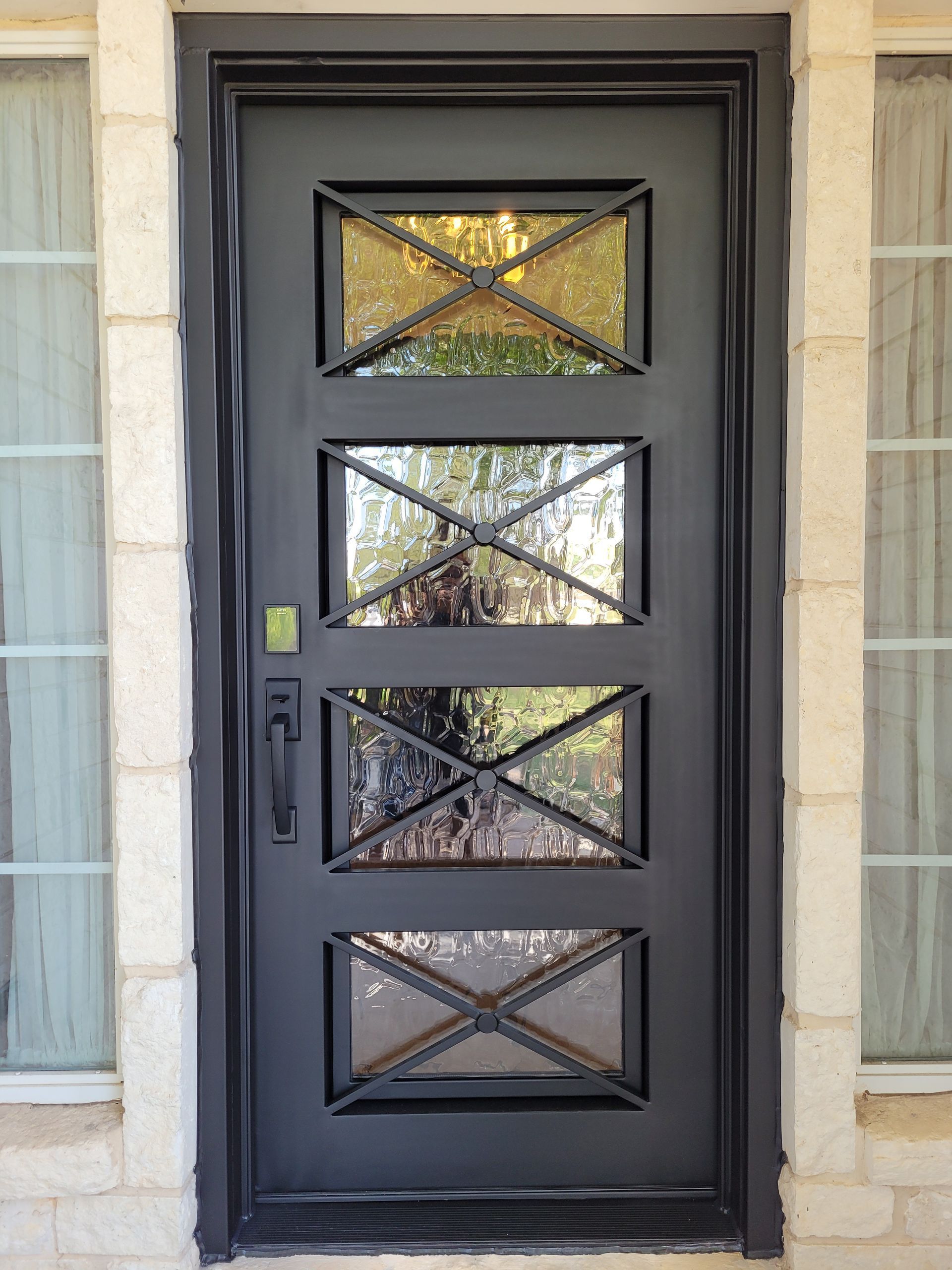 A black door with a stained glass design on it