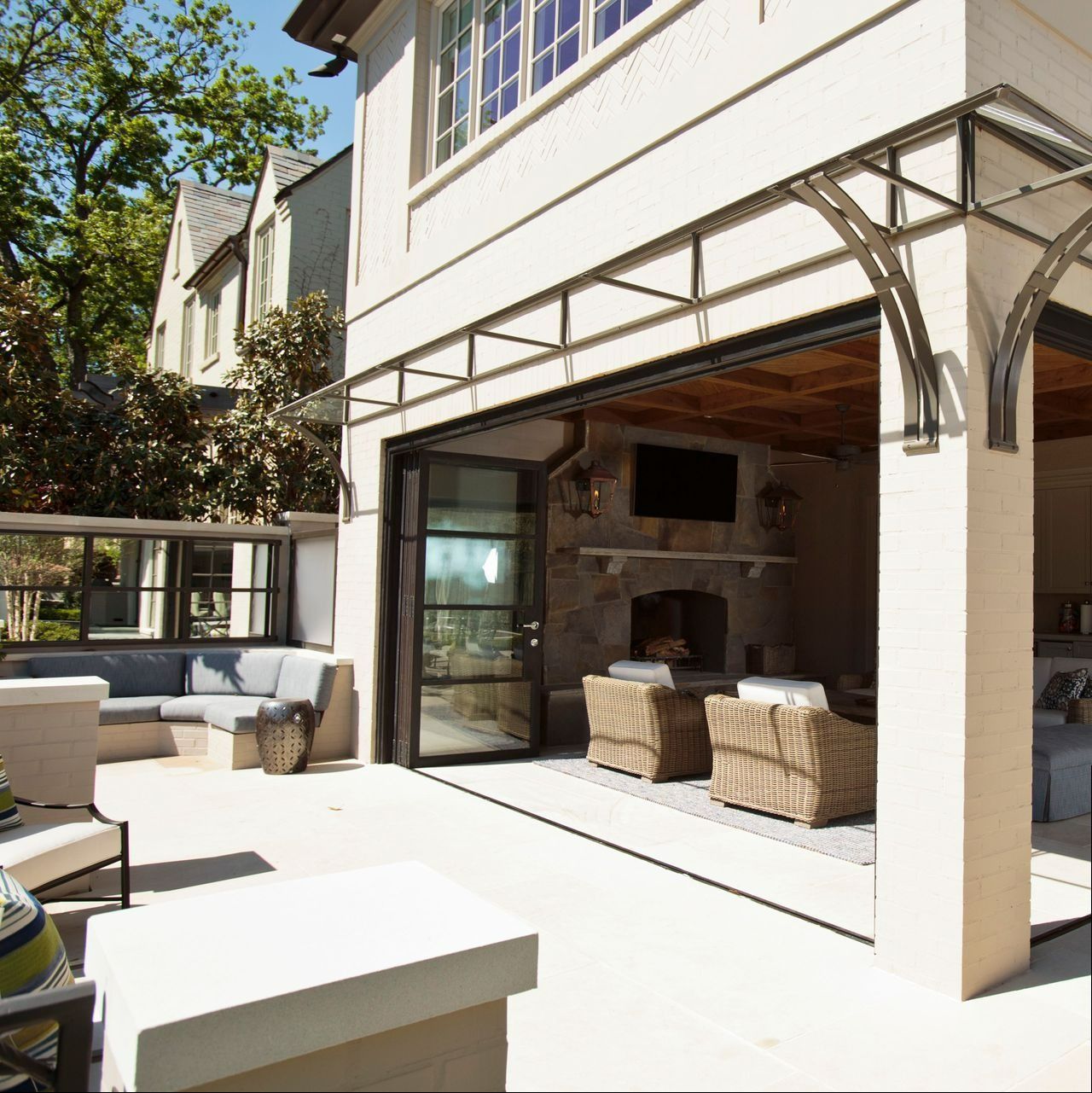 A white house with a bifold leading to a living room