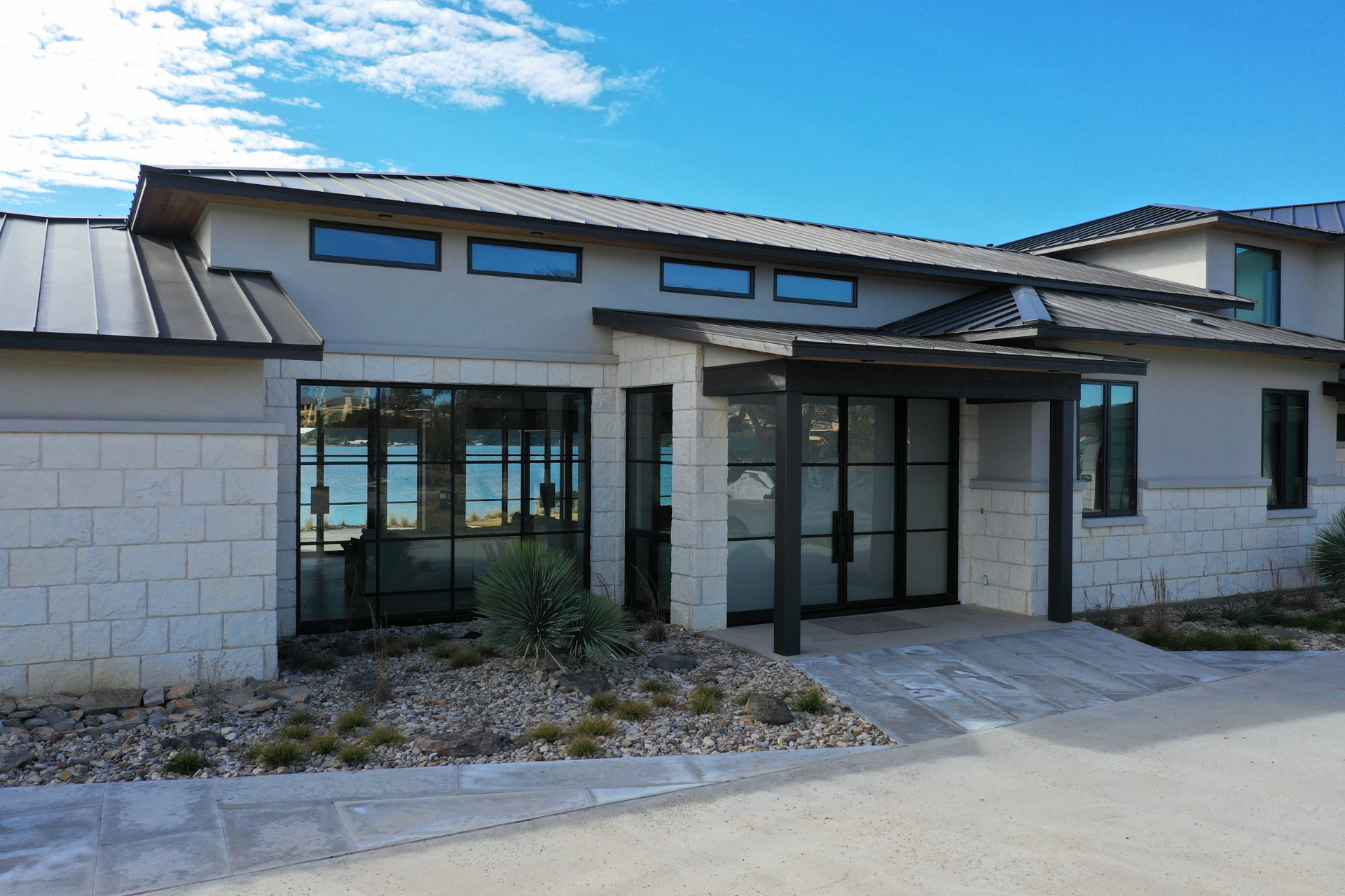 a large house with a lot of windows and a metal roof