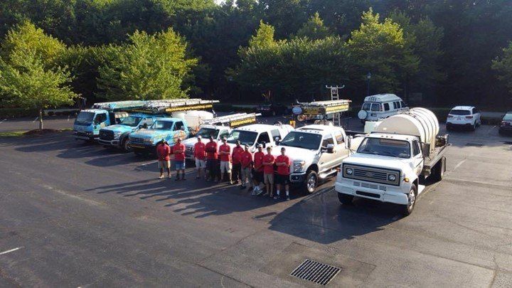 Our team standing with our trucks