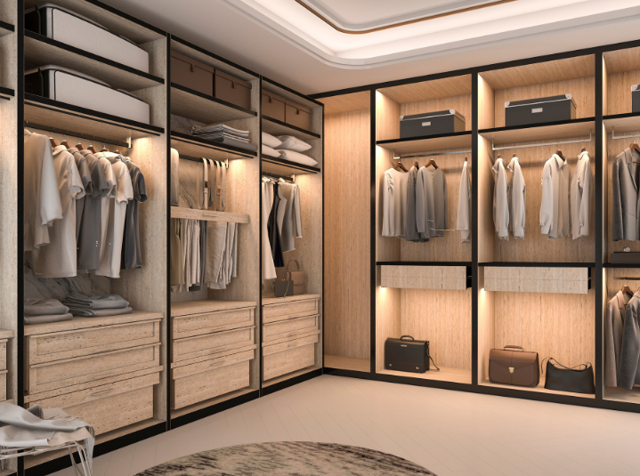 A modern, well-lit walk-in closet with floor-to-ceiling wooden shelving, integrated LED lighting, and hanging clothes.