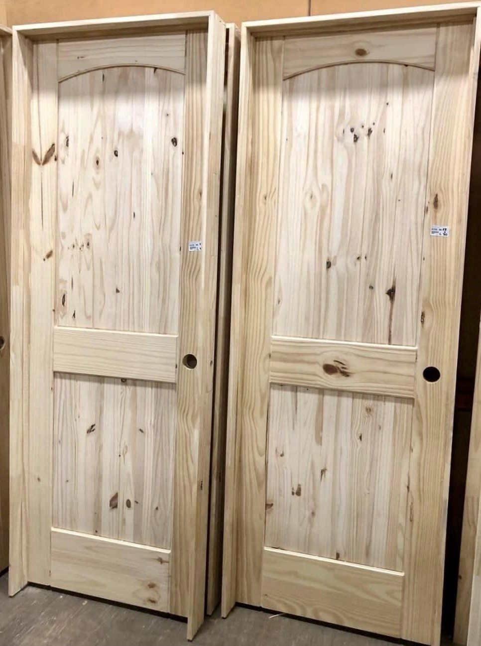 Two unfinished knotted pine doors