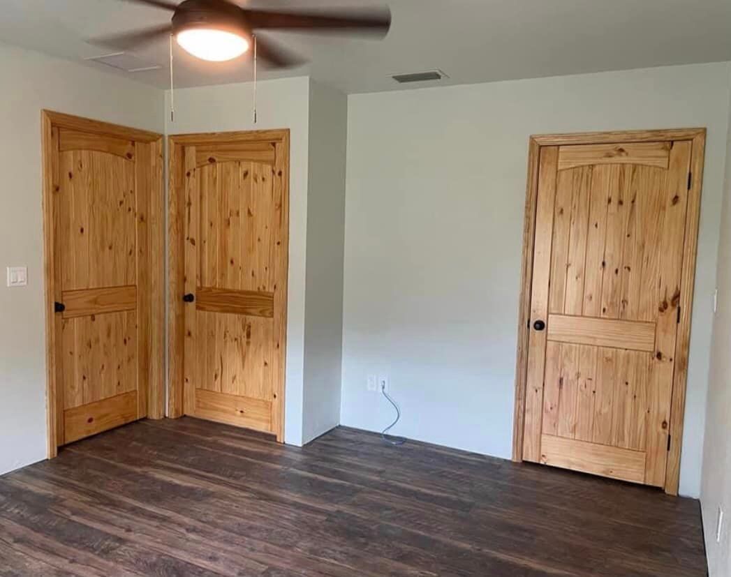 Room with three knotted pine doors