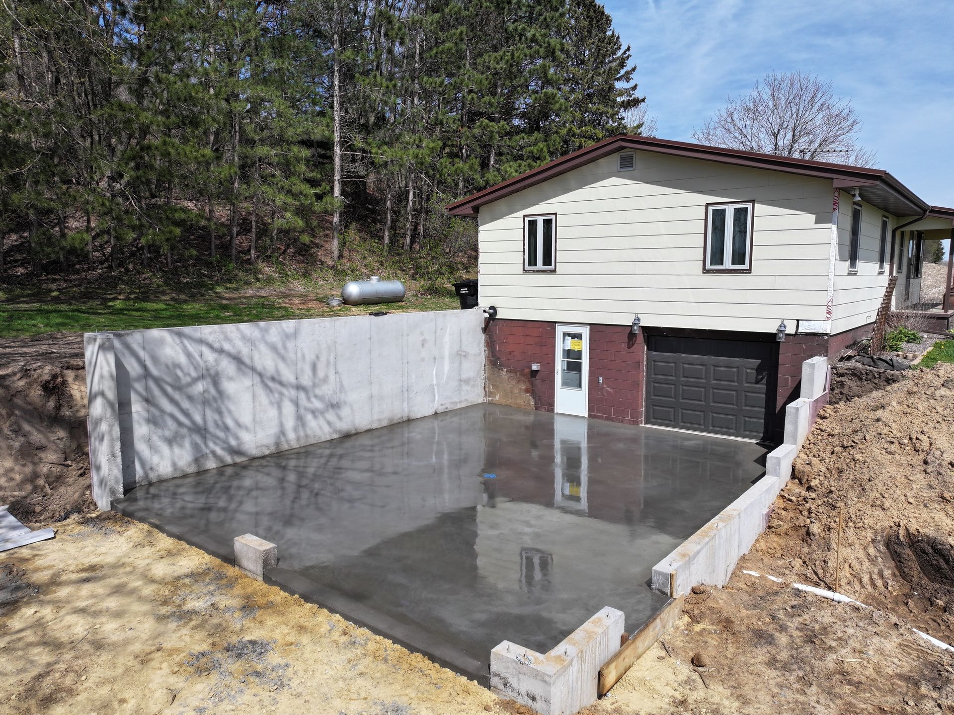 A garage is being built in front of a house.