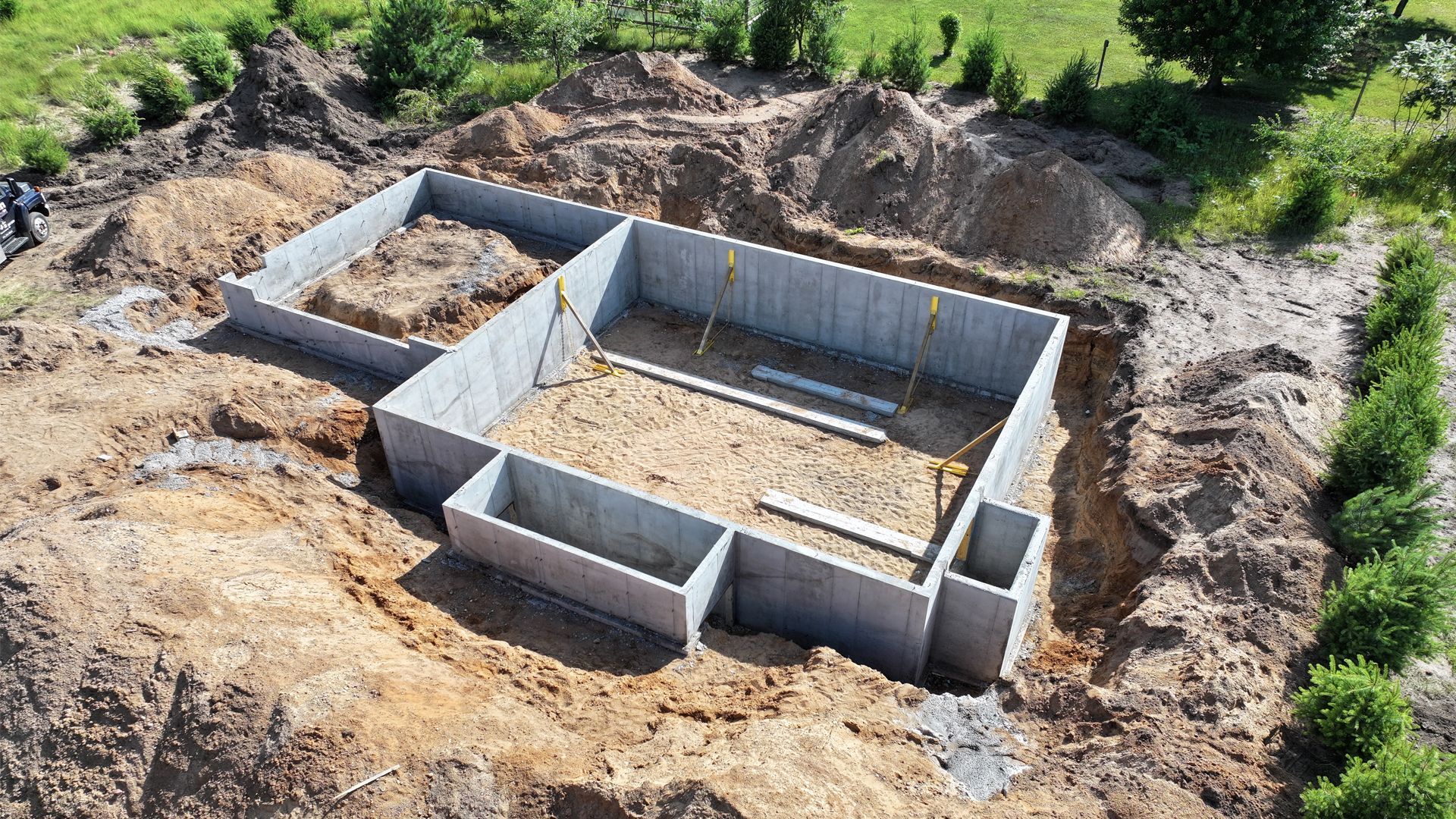 An aerial view of a concrete base for a house under construction.