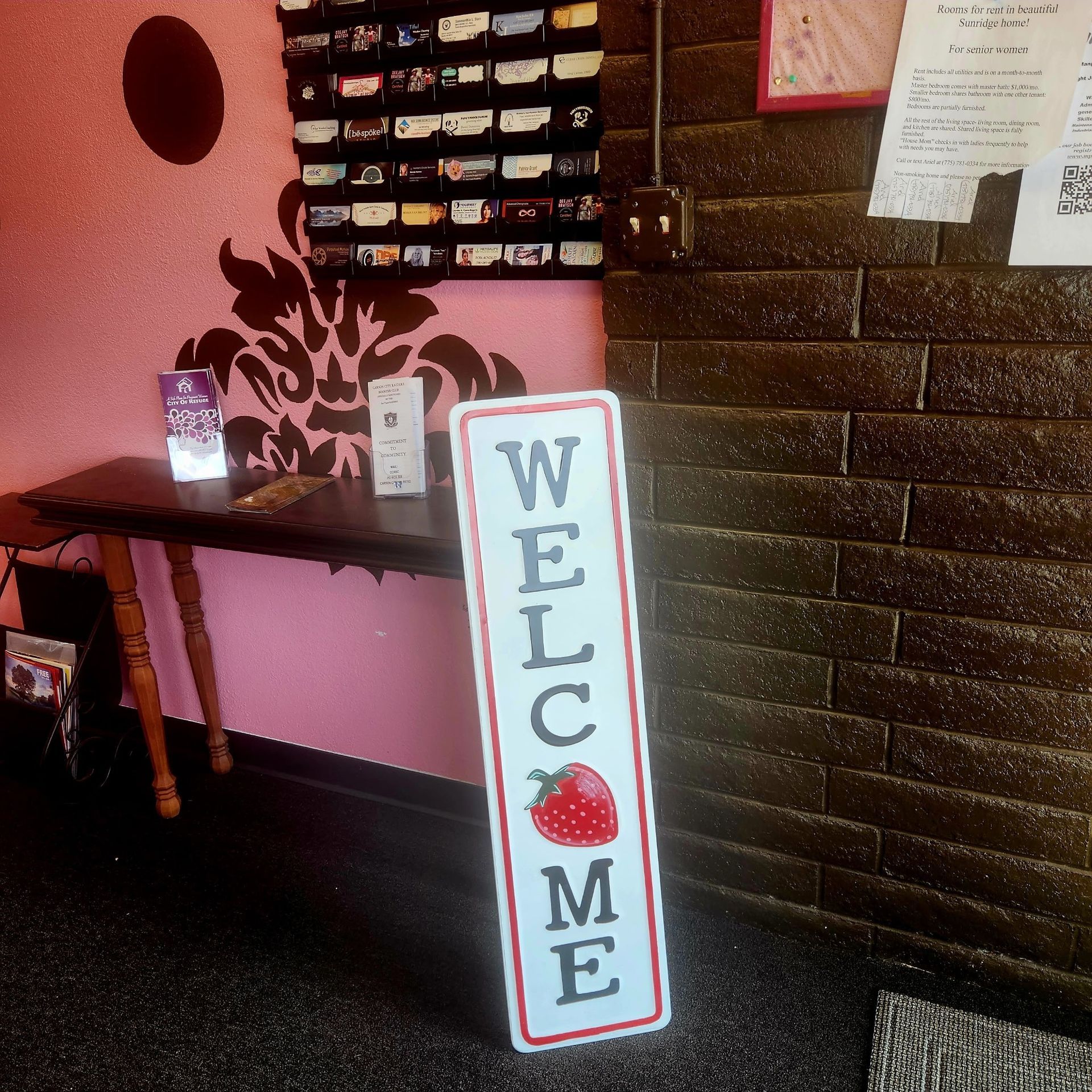 A welcome sign with a strawberry on it