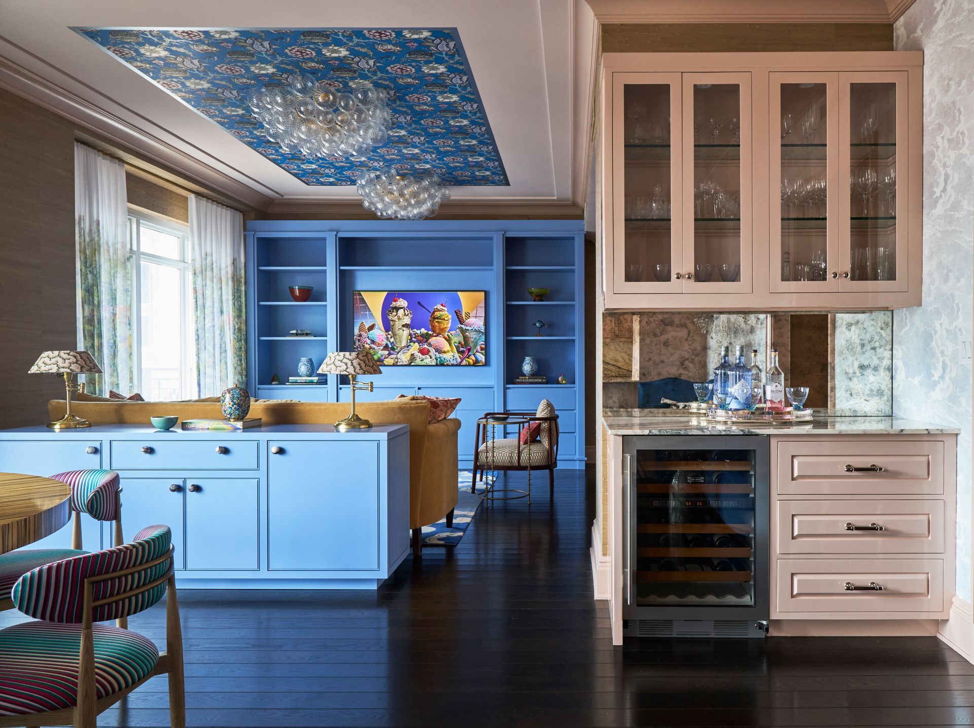 A living room with purple and yellow furniture and a fireplace