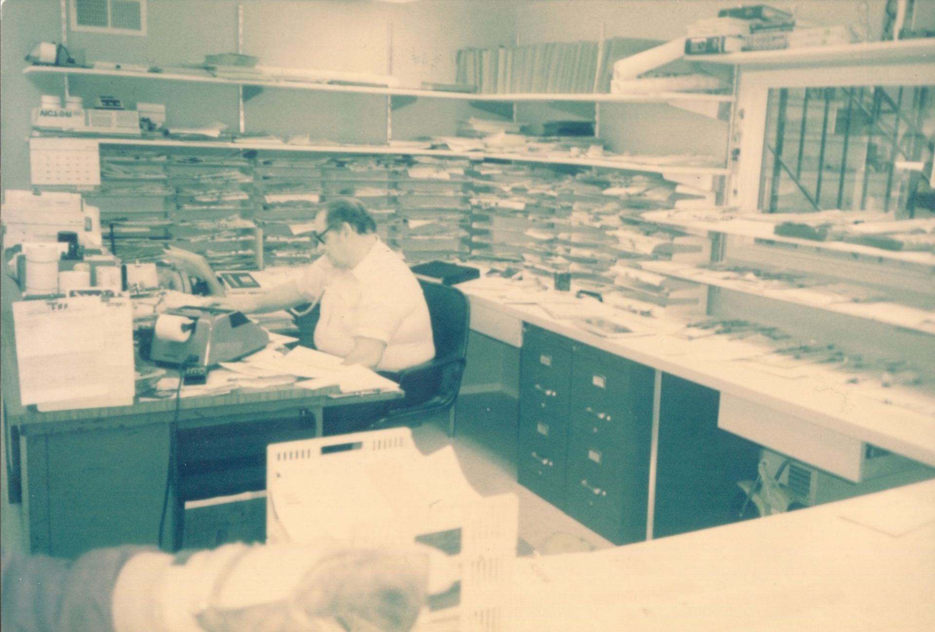 A man is sitting at a desk in an office