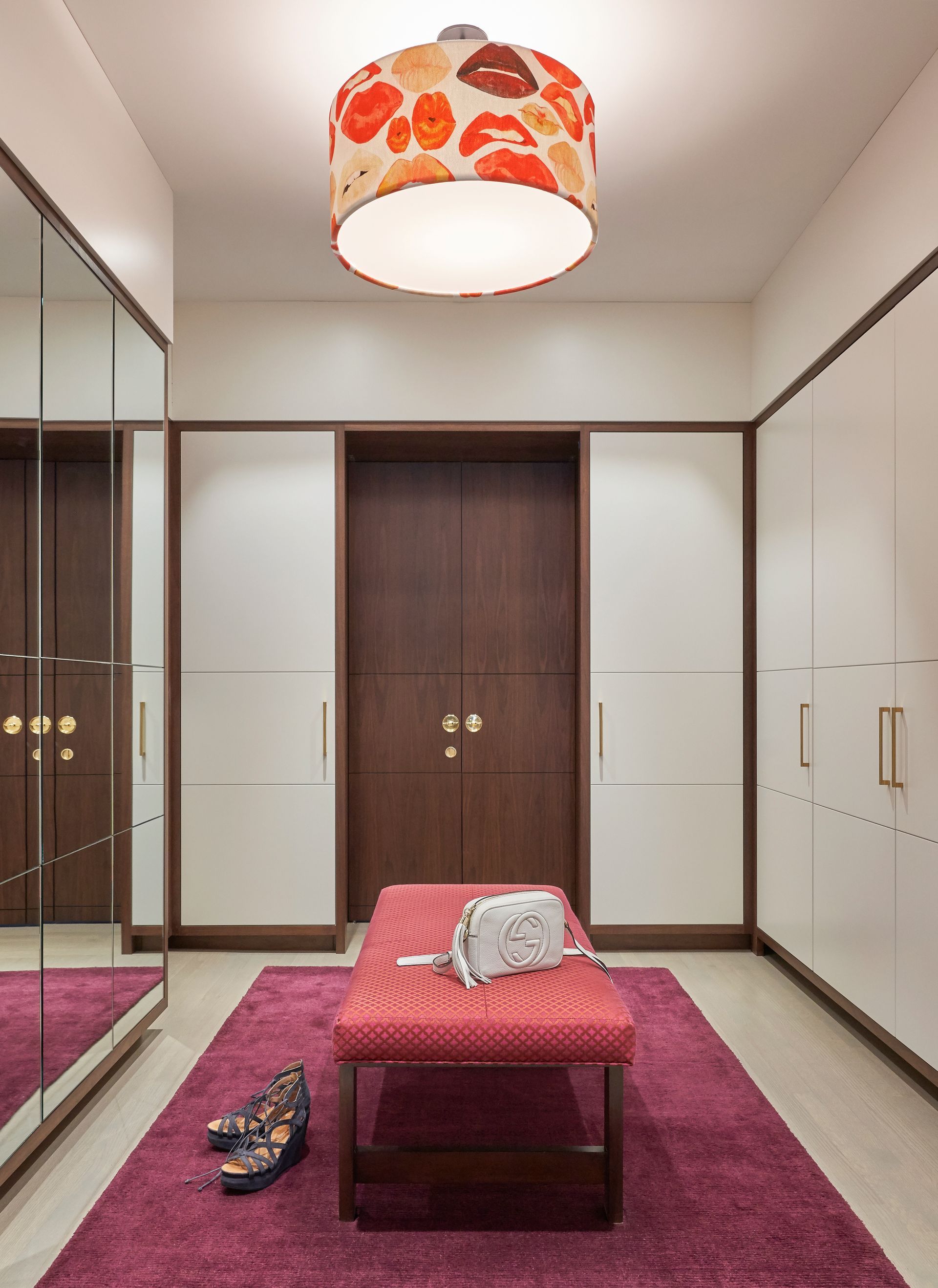 A closet with a bench and a purse on it