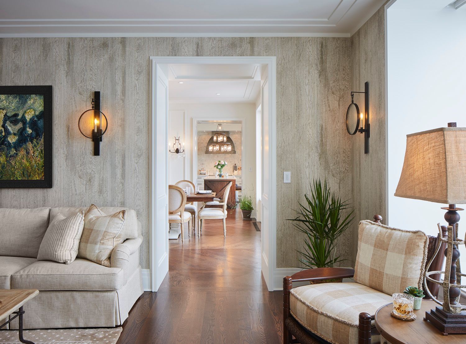 A living room with a couch, chair, table, and lamps.