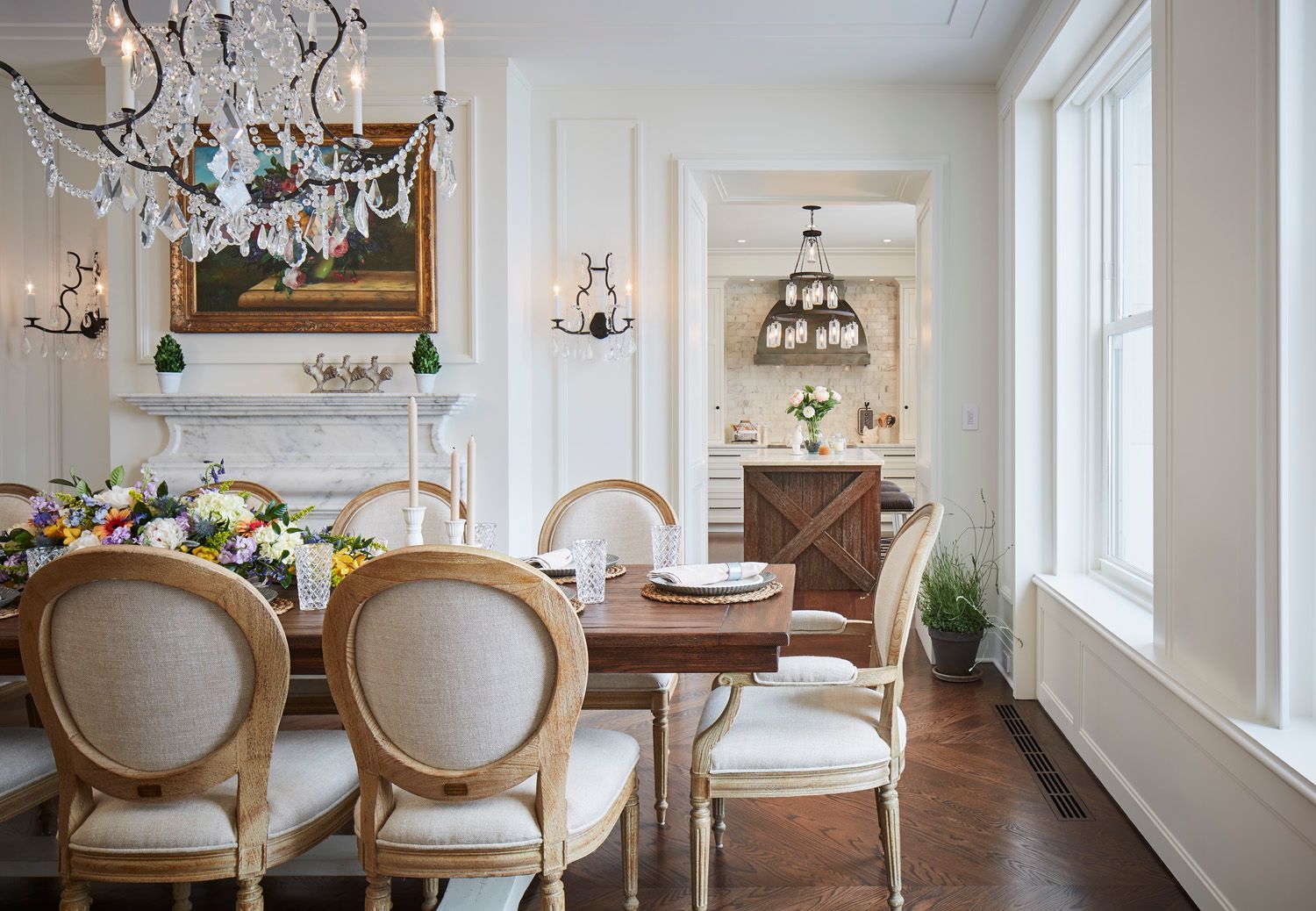 A dining room with a table and chairs and a chandelier.