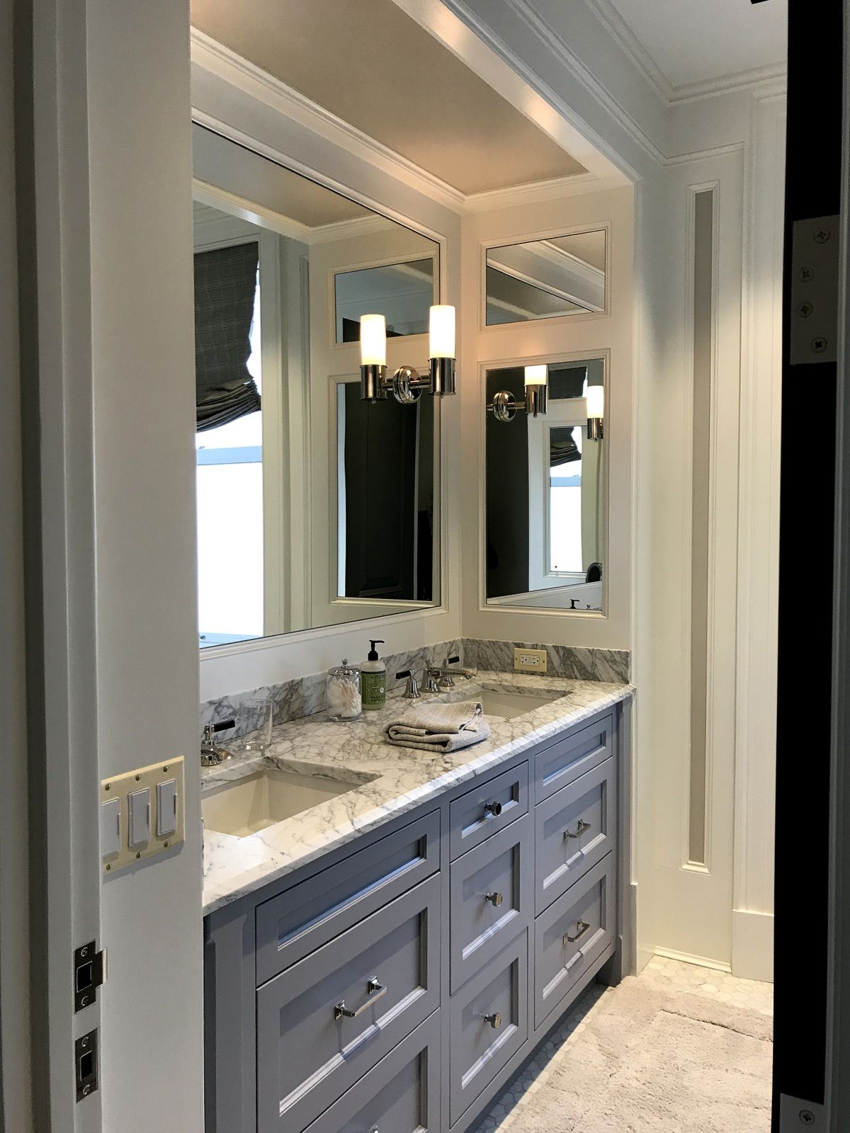 A bathroom with two sinks and two mirrors.