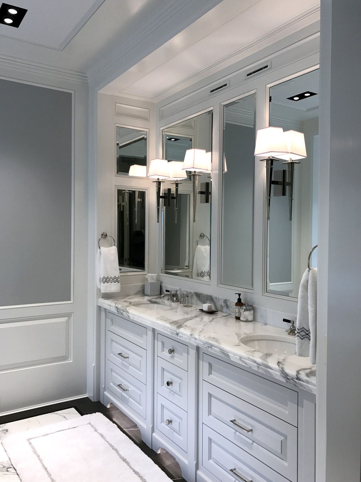 A bathroom with two sinks and two mirrors.