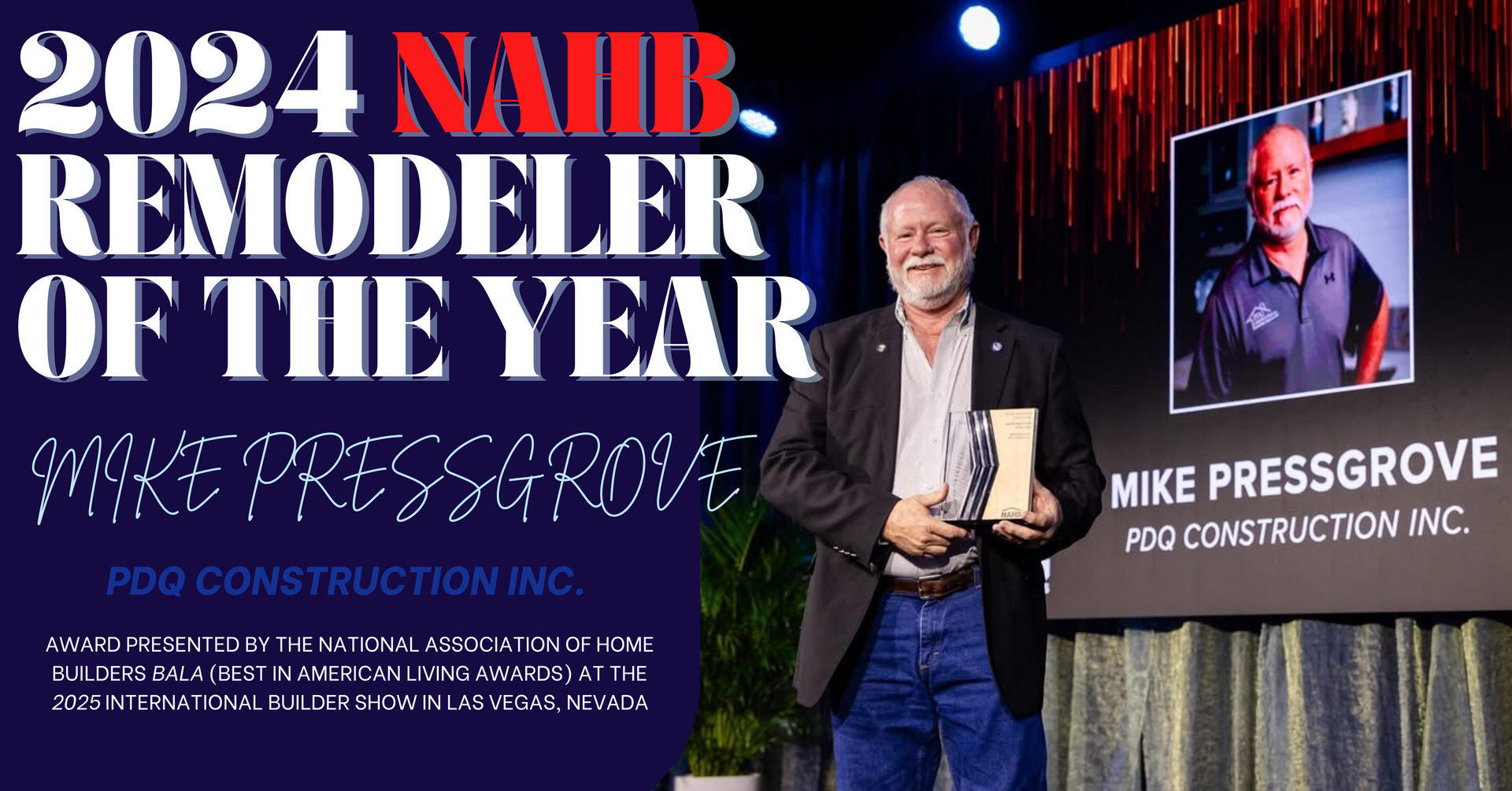 A man is standing on a stage holding an award.