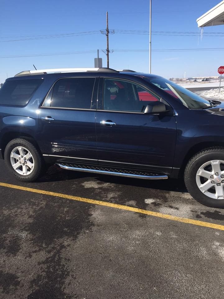 Dark blue SUV parked outdoors on a sunny day.