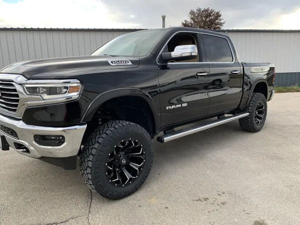Black Ram pickup truck with chrome accents and large black wheels.