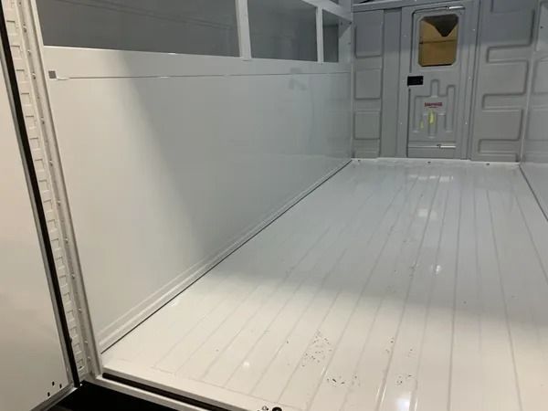 Empty white truck interior with a ridged floor.