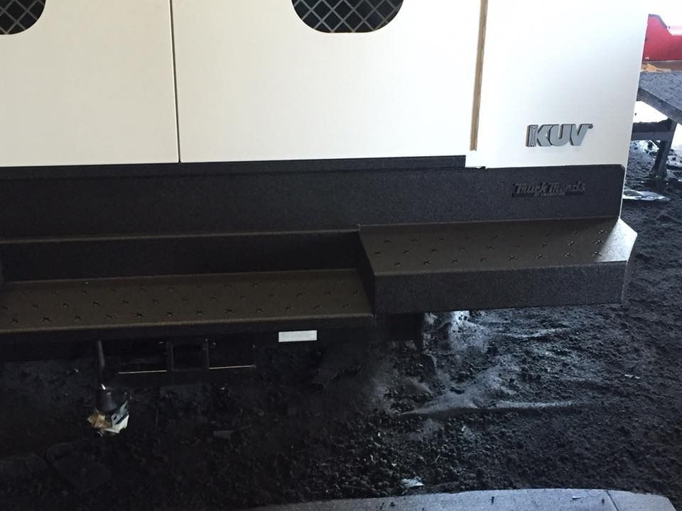 White and black generator with built-in steps outdoors. 