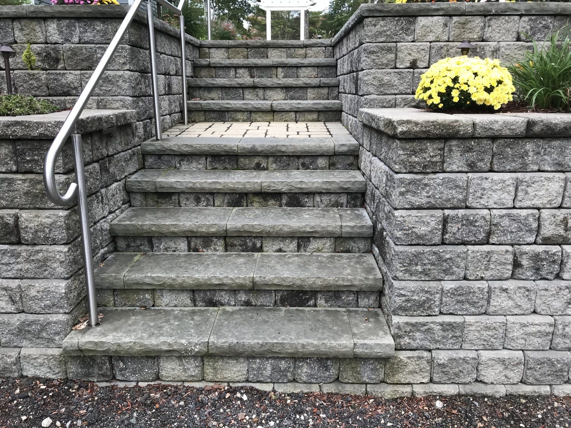 A set of stairs leading up to a stone wall