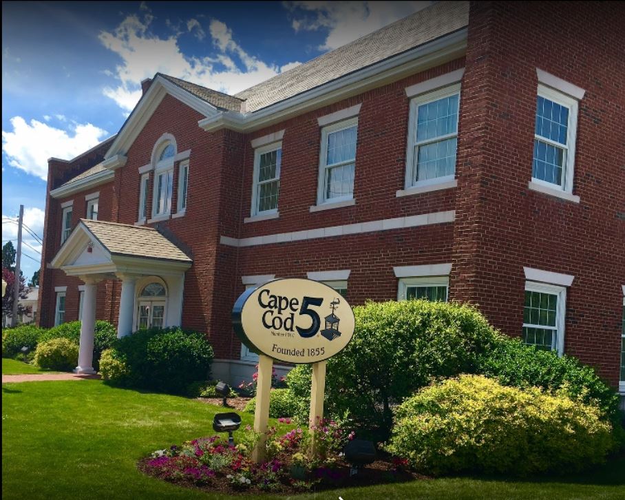 A large brick building with a sign that says Cape Cod 5