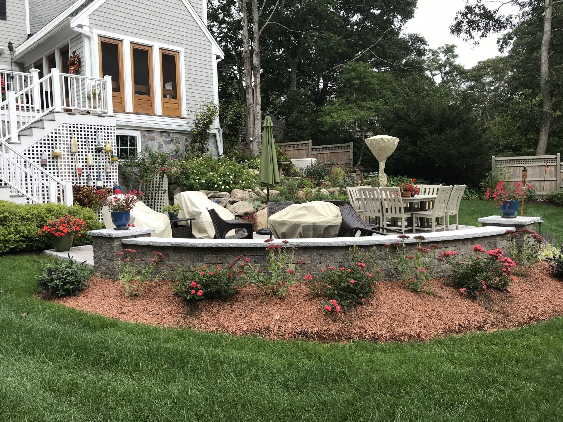 There is a fire pit in the backyard of a house