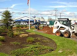 A bulldozer is moving dirt in a garden