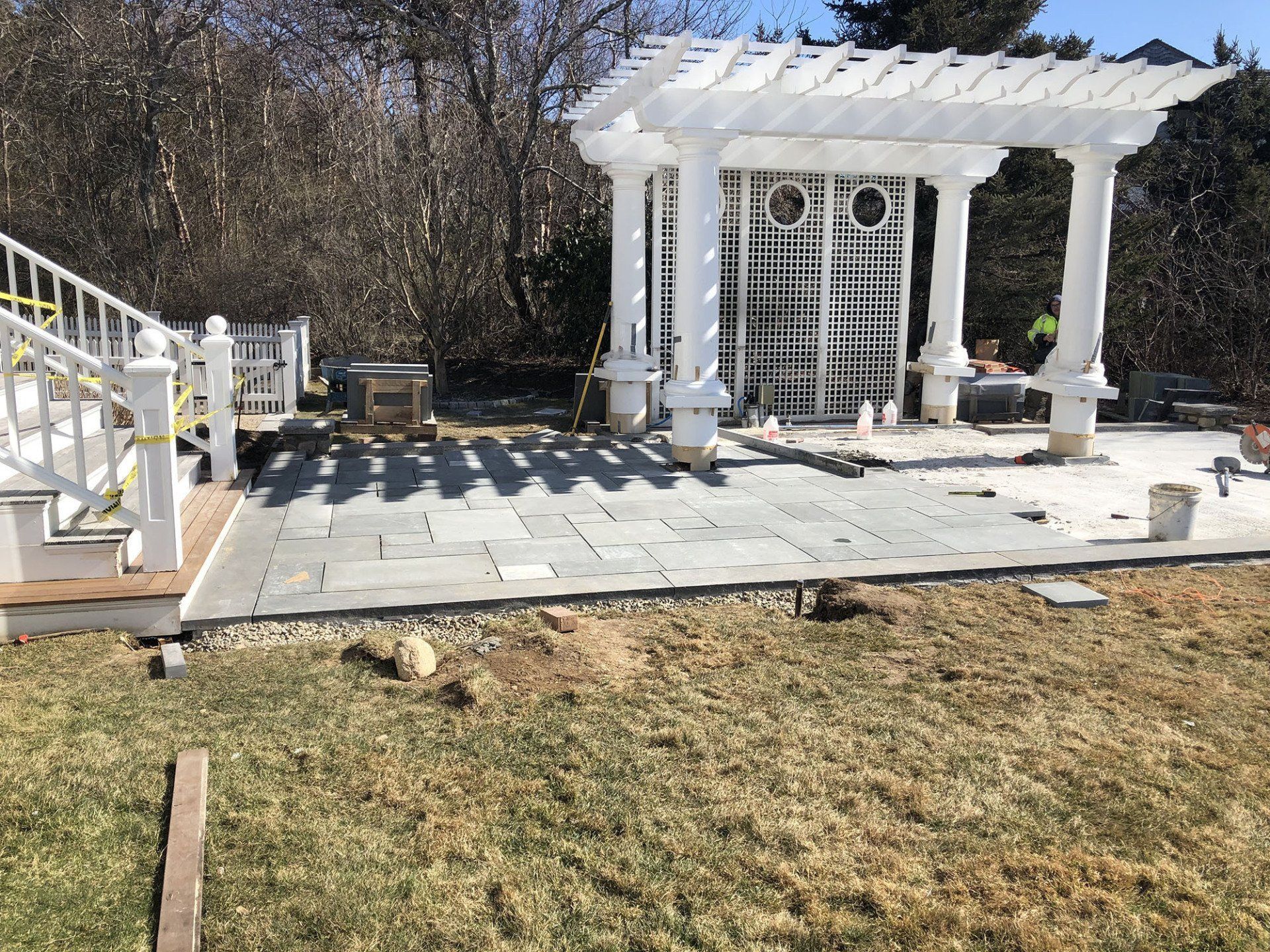 A patio is being built in the backyard of a house.