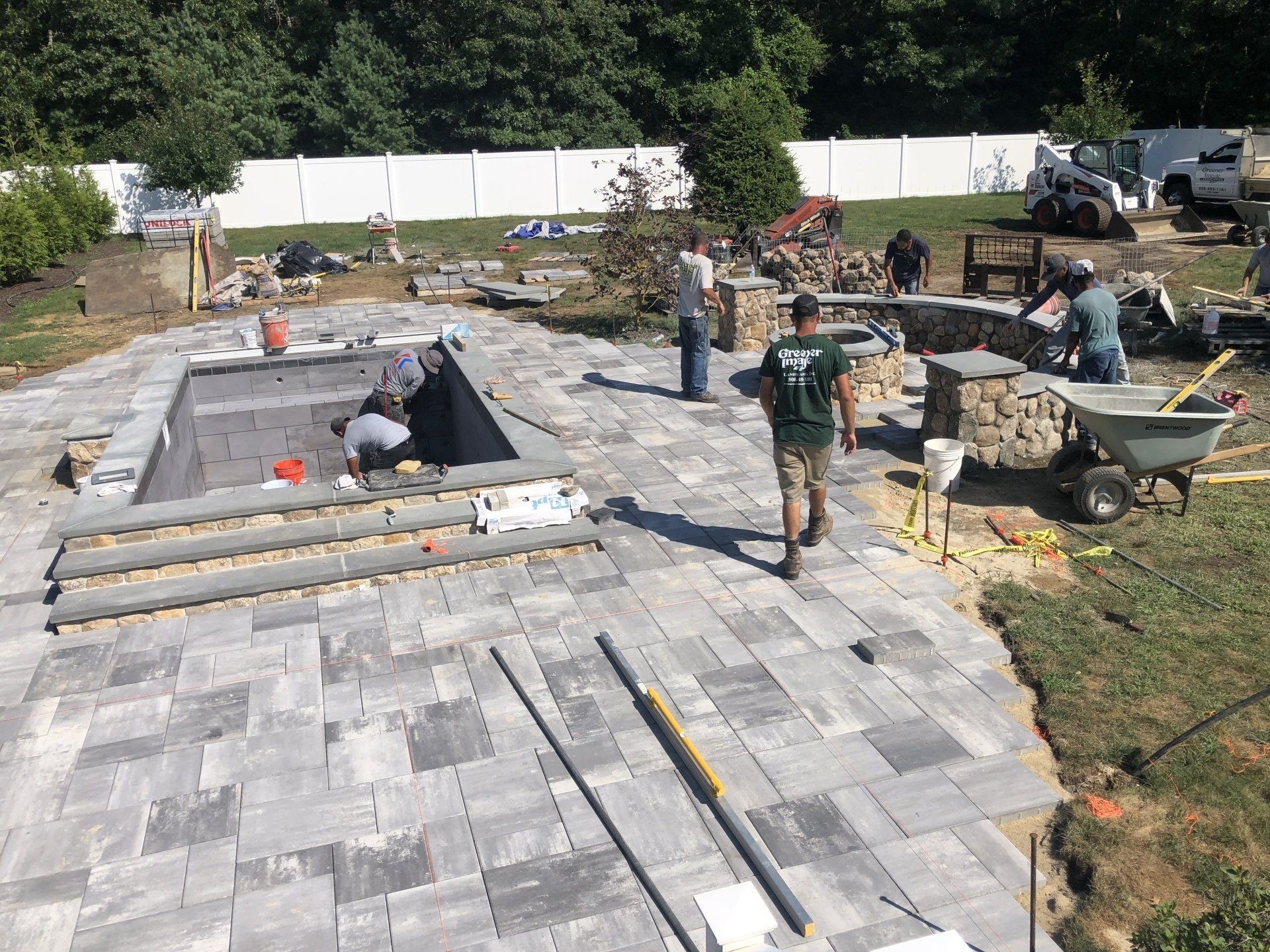 A group of people is working on constructing a swimming pool.