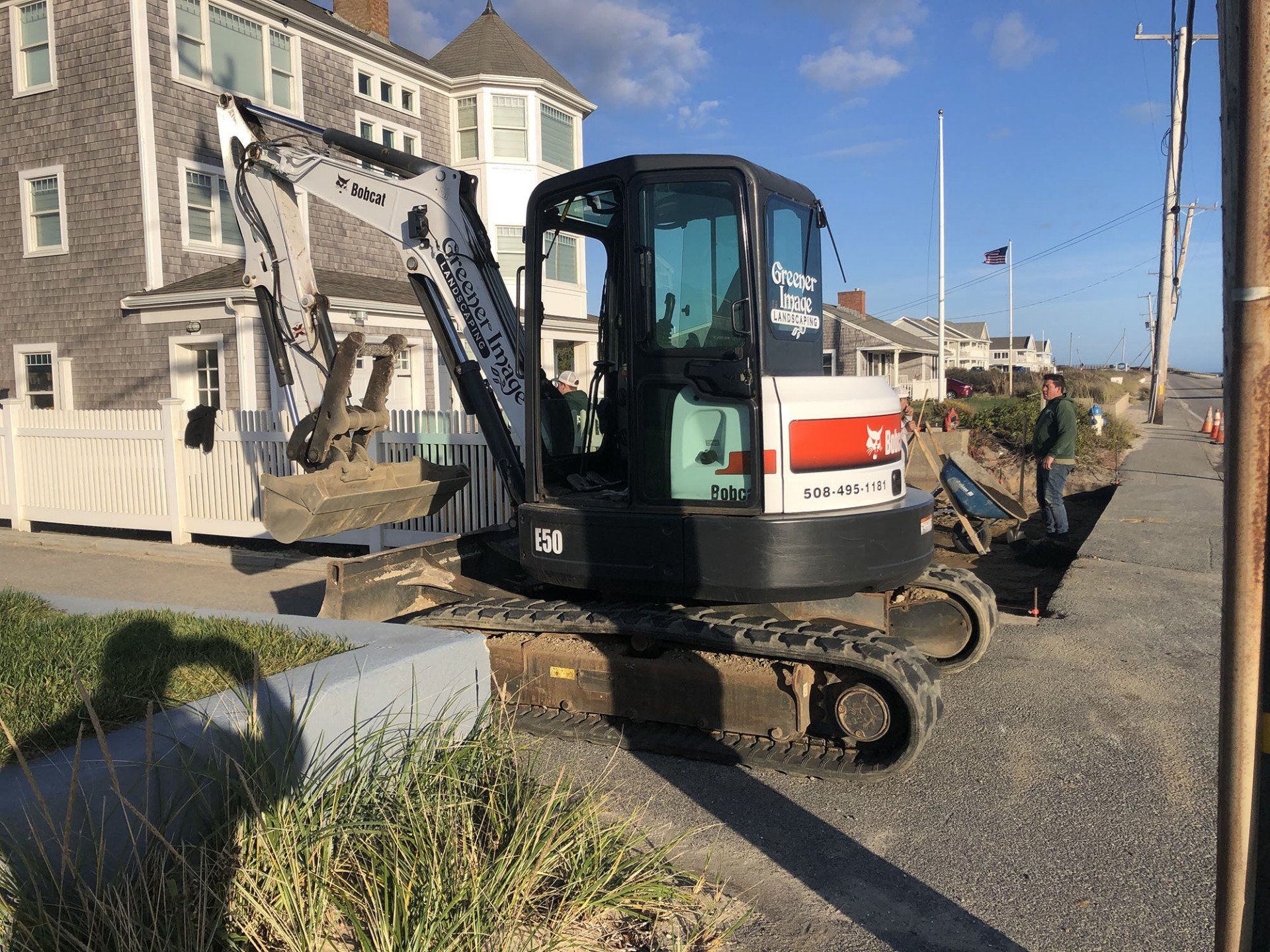 A bobcat excavator is being used for the construction of a driveway.