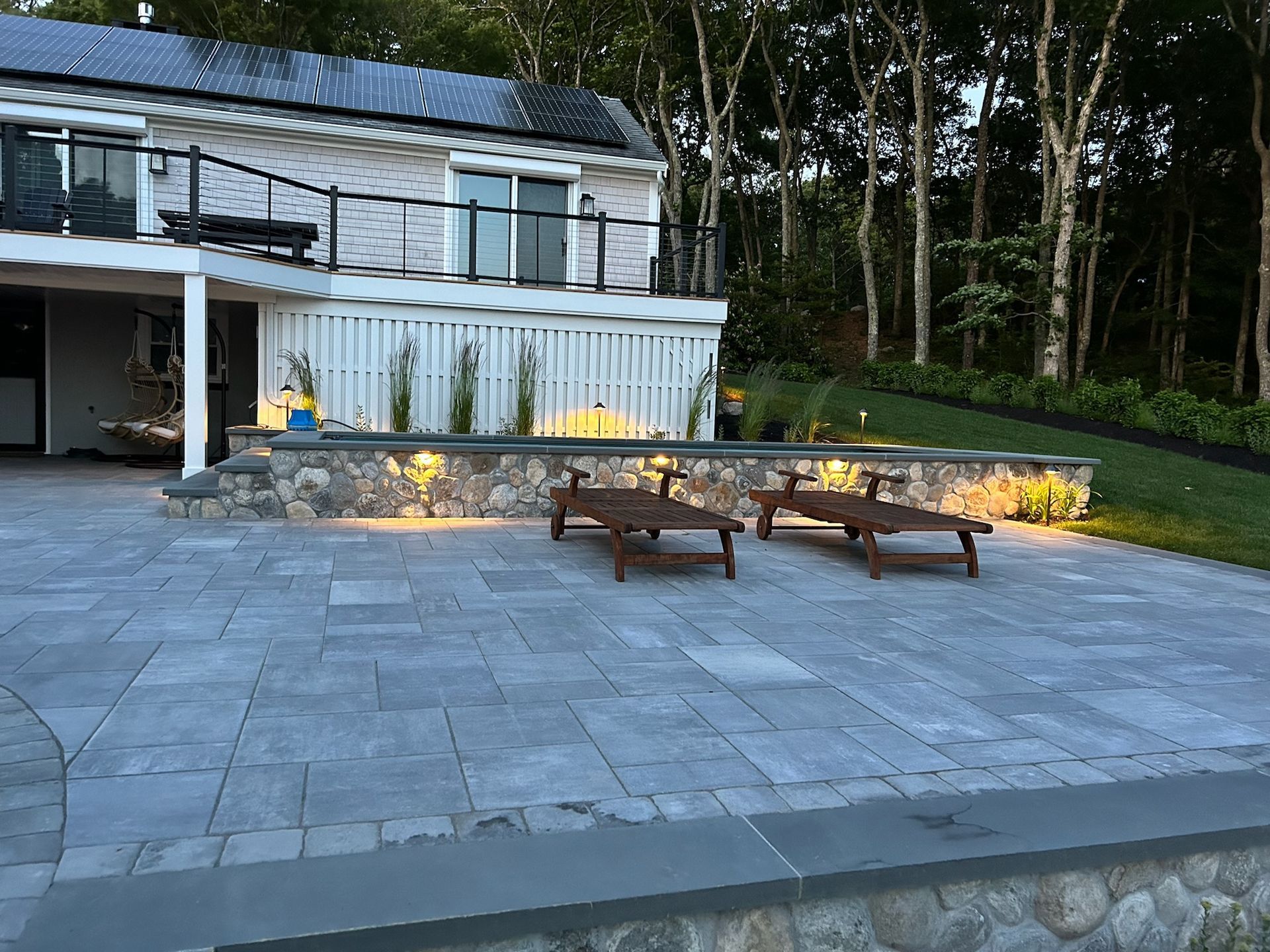 A patio with chairs and a house in the background