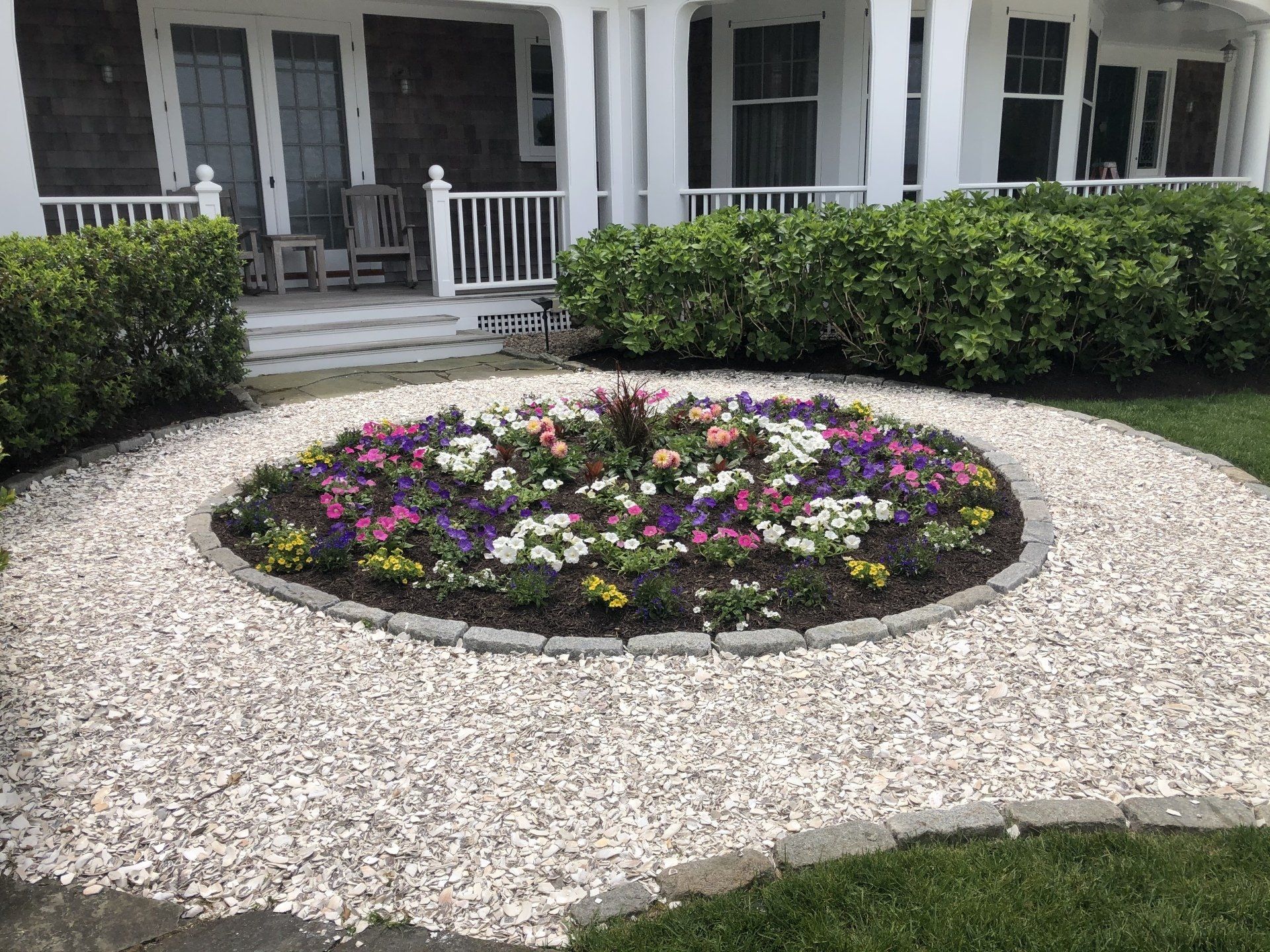 A garden with a sign that says no parking in front of a house