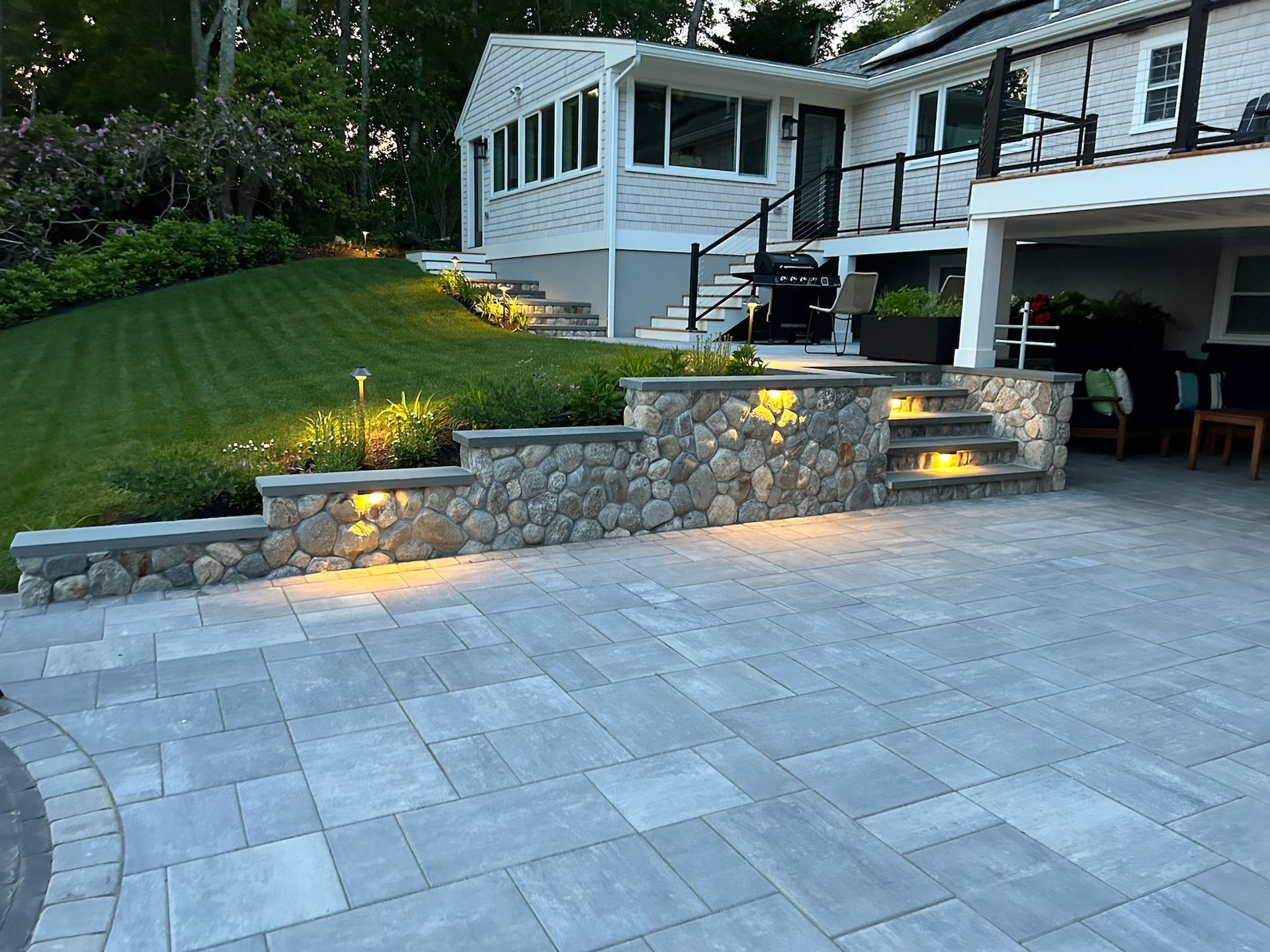 A large white house with a patio and stairs in front of it