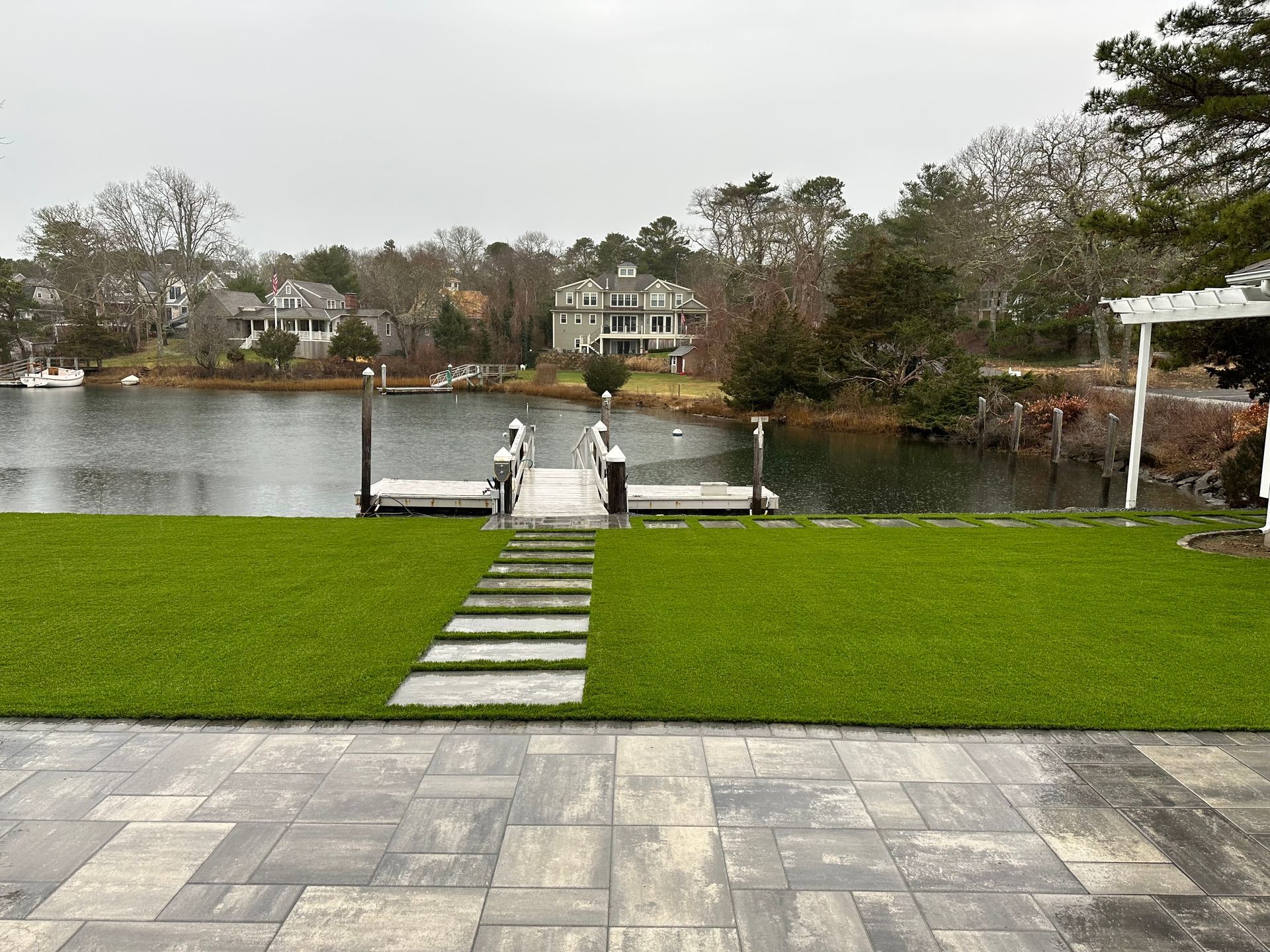 a patio with a view of a lake and a dock