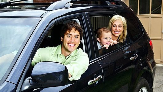 Happy family inside their car