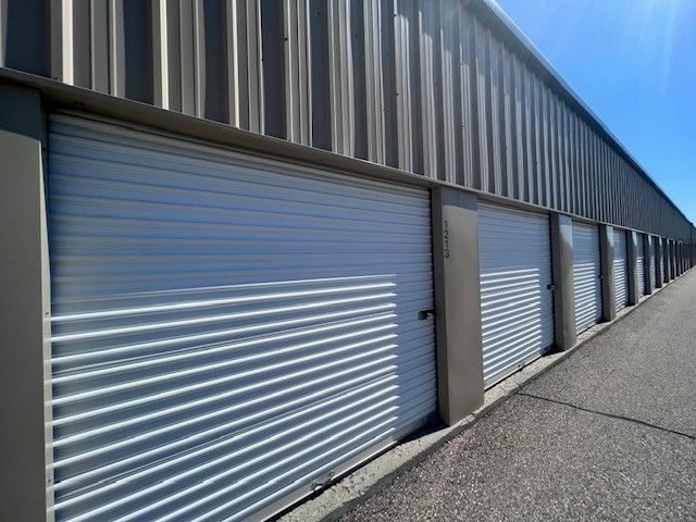 A row of storage units with white doors 