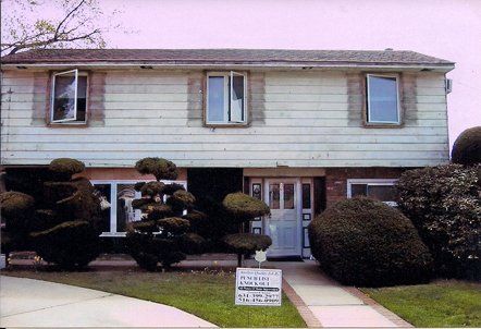 A house with a for sale sign in front of it