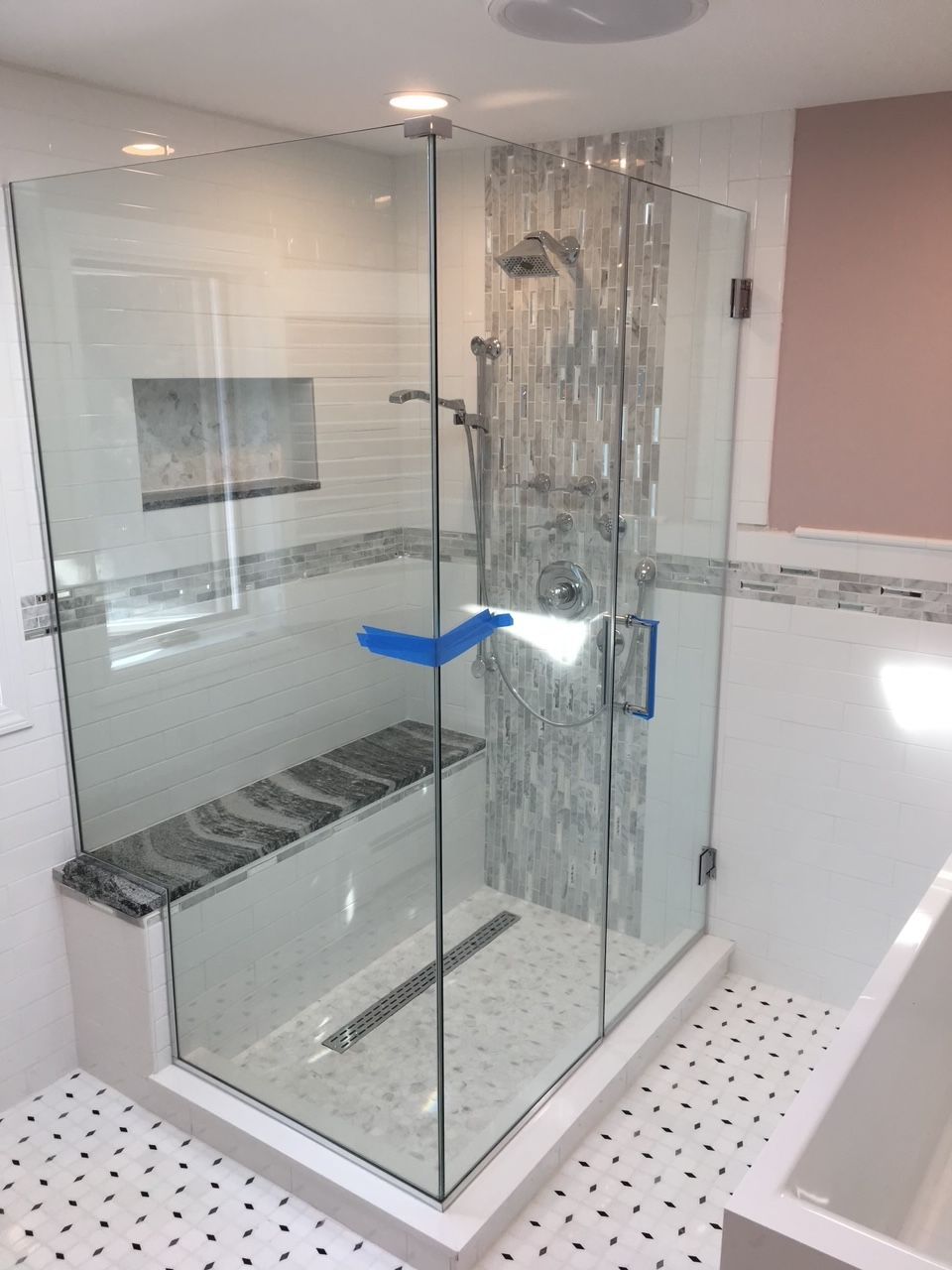 A bathroom with a walk in shower and a bathtub