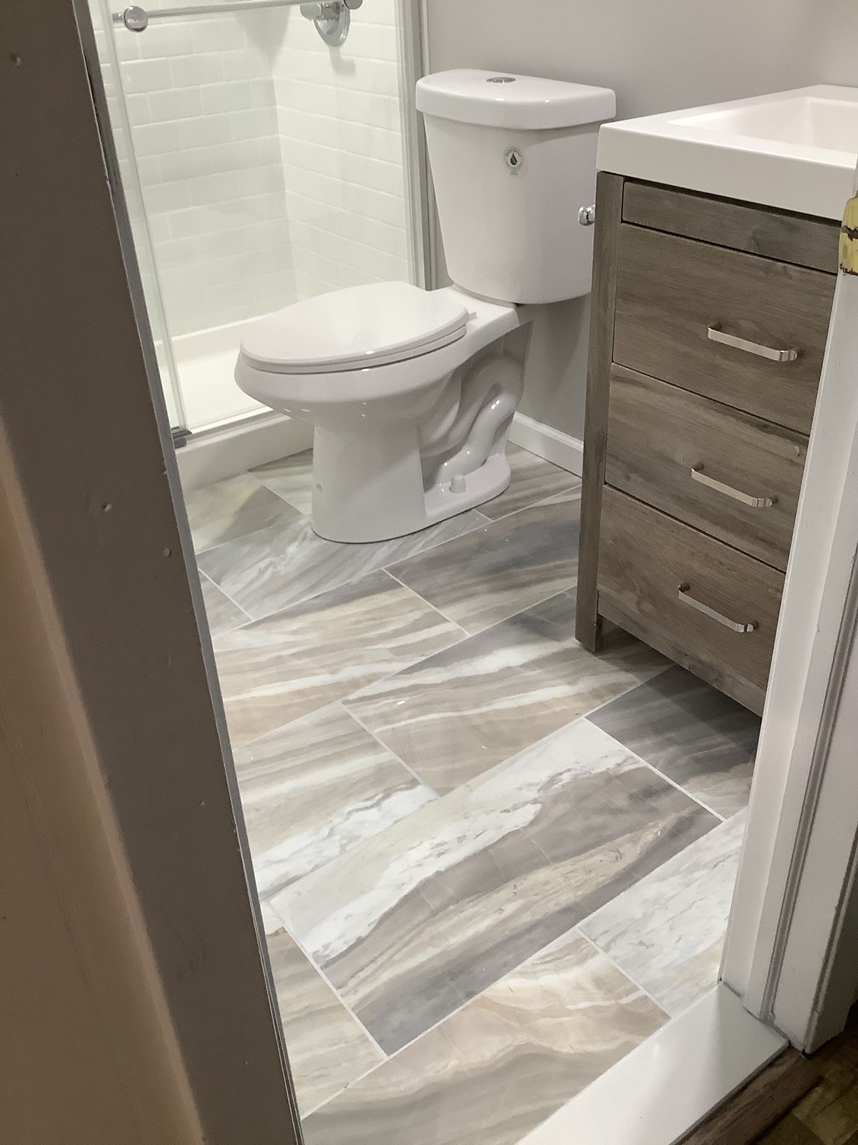 A bathroom with a toilet, sink, and shower