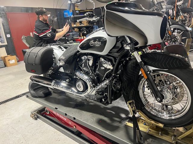 A car is being painted in a garage.
