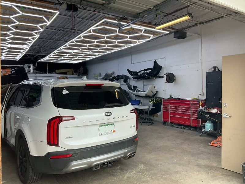 A white suv is parked in a garage.