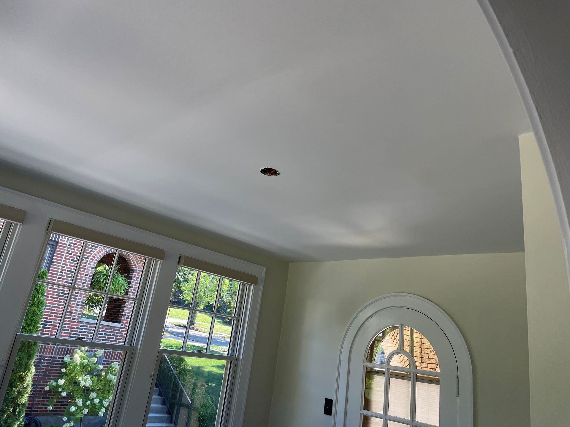 A room with a ceiling that has a hole in it