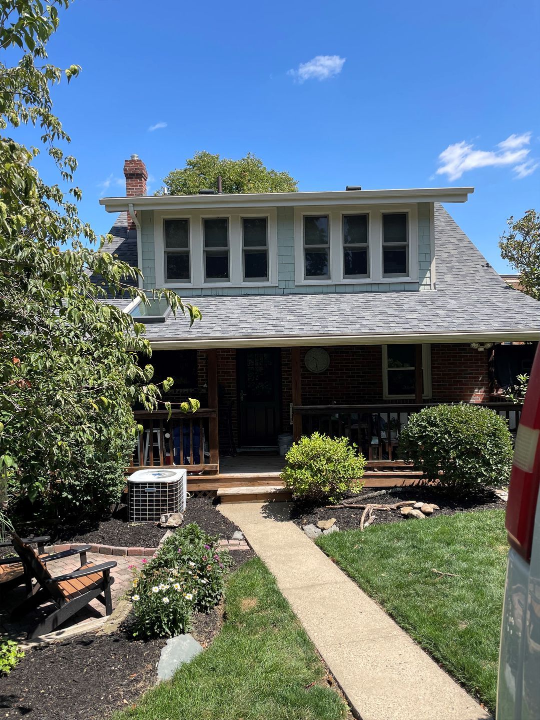 A house with a lot of windows and a walkway leading to it.