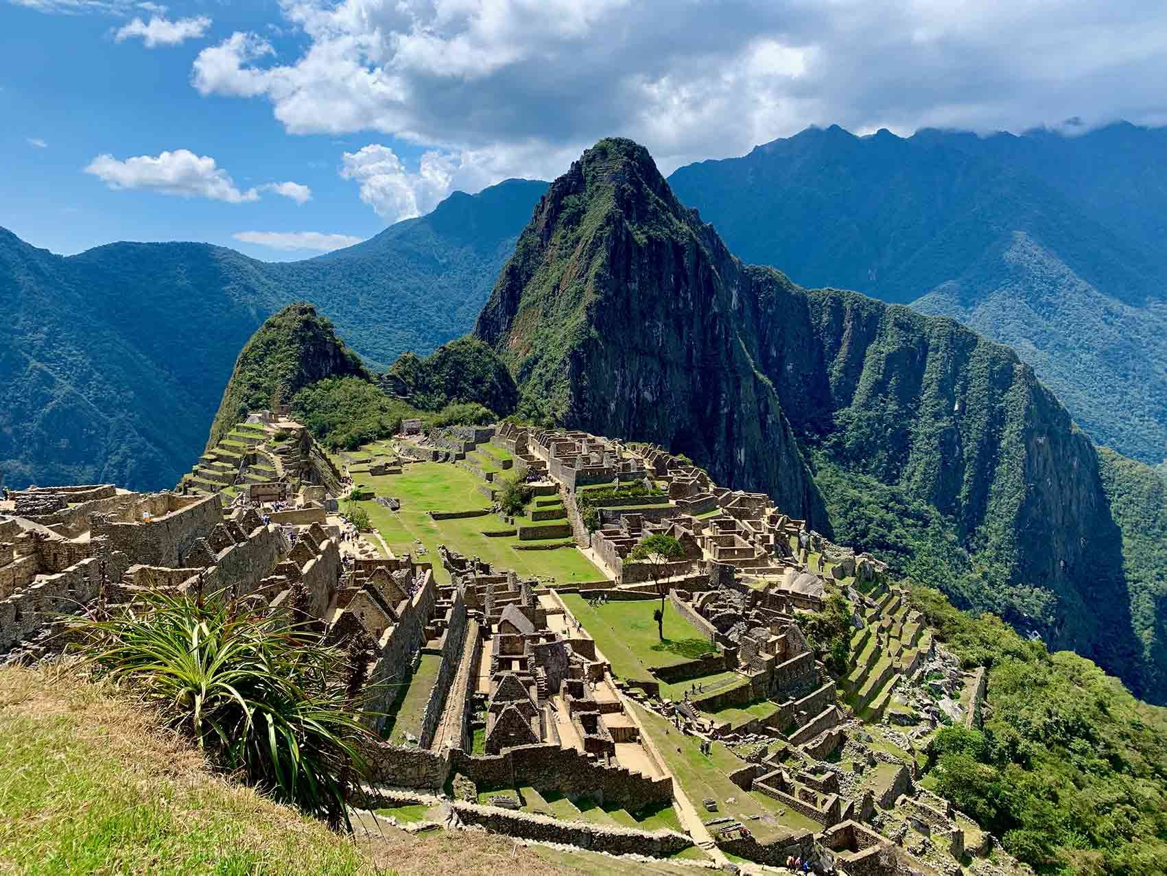 The ruins of the inca city of machu picchu are surrounded by mountains.