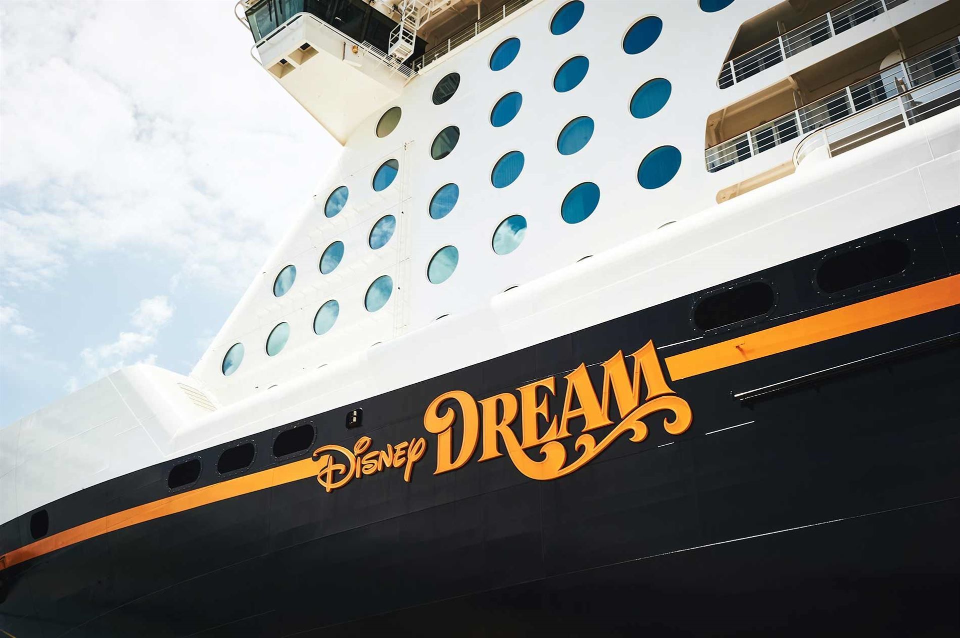 A disney dream cruise ship is docked in the water
